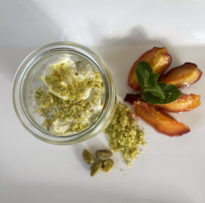 Pistachio mousse with crème fraîche and roasted peach