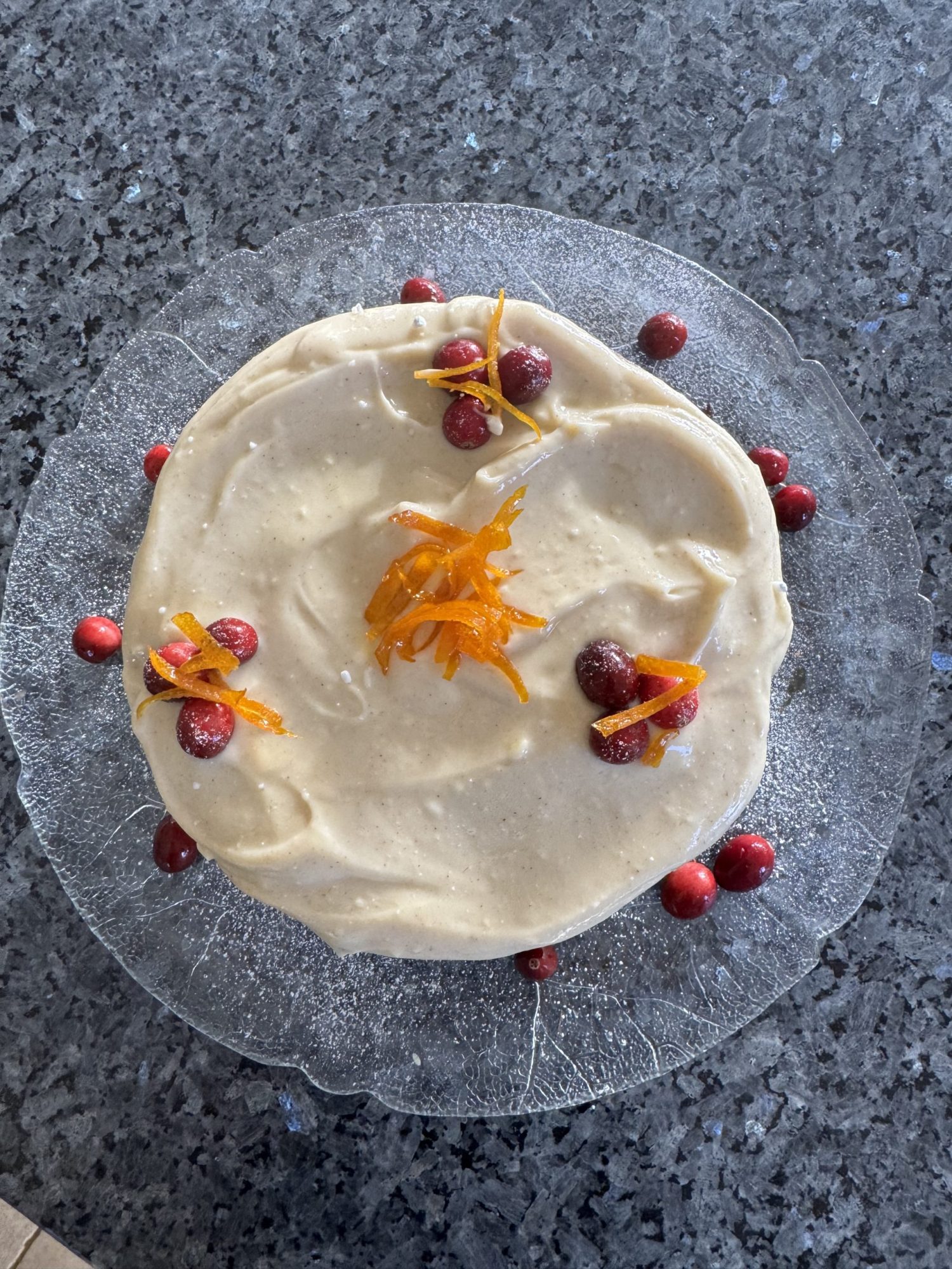 Spiced ginger Christmas cake decorated with caramelised orange slices and fresh cranberries