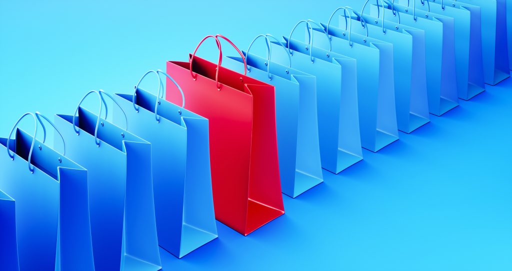 Shopping Bag Standing Out From Teal Shopping Bags over Teal Background stock photo
